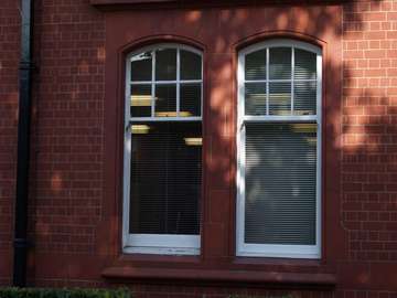 2 white Pvcu sliding sash windows in Liverpool. The client required an arched headed sash window to match there existing windows. Our new Upvc sliding sash window comes with our new run through horns, large bottom rile. And but joining to look like traditional timbre sliding windows Our new sliding box sash window also has a large bottom rail. Our Liverpool sash window installation team carried out the contract in two days